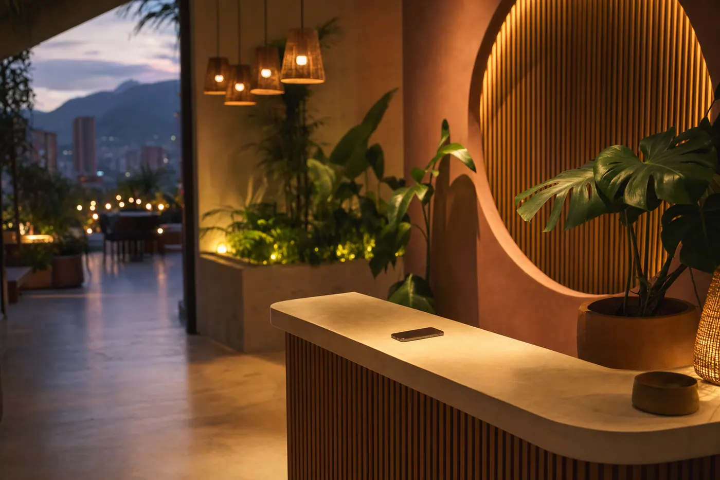 A warm, modern small-business reception in Medellin at dusk, lit softly
