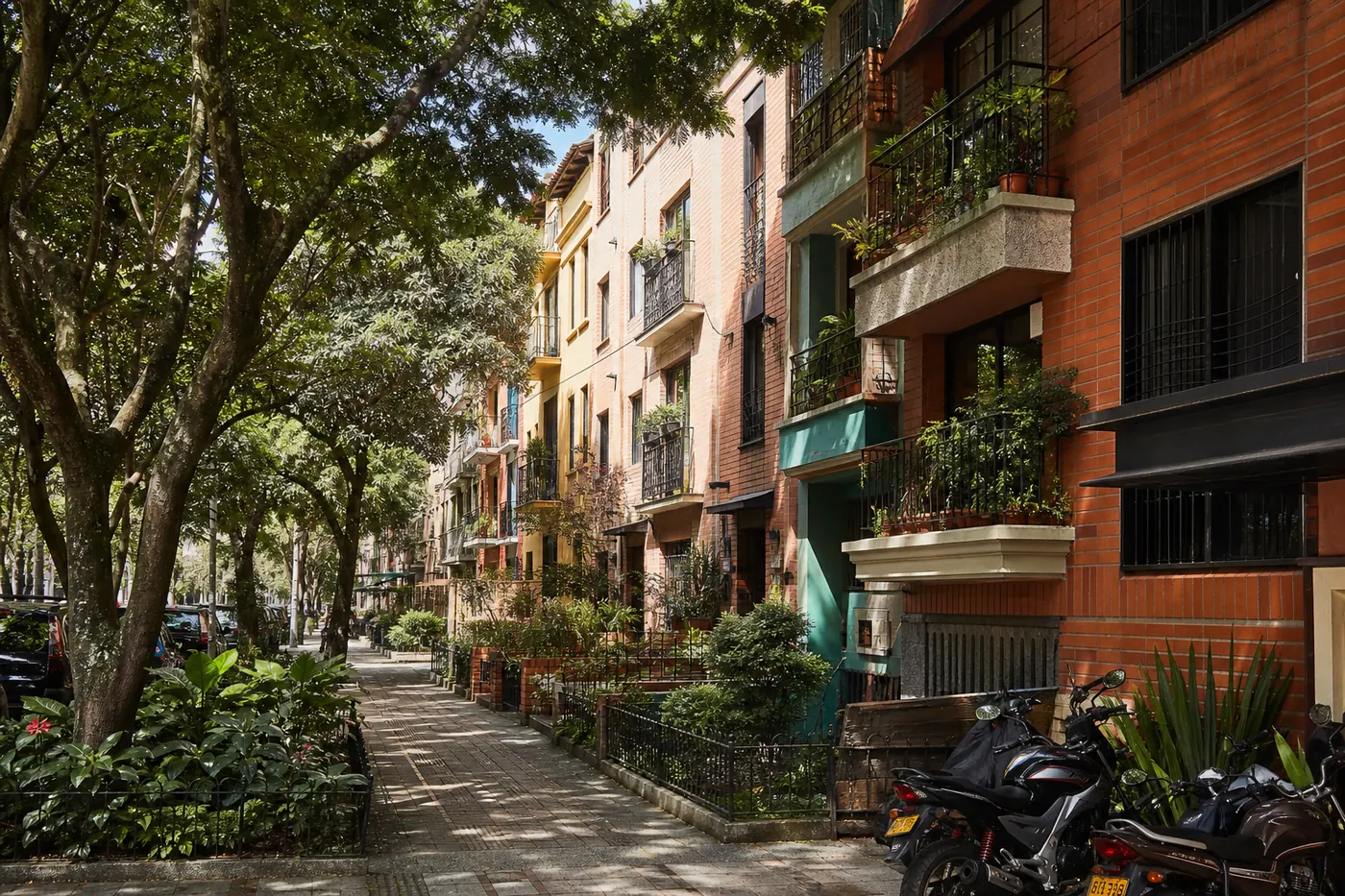 Apartment building on a tree-lined street in Laureles, Medellín — typical residential rental market