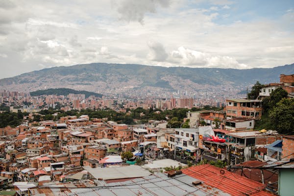 Panoramic view of Medellín with mountain backdrop showing the city's diverse neighborhoods