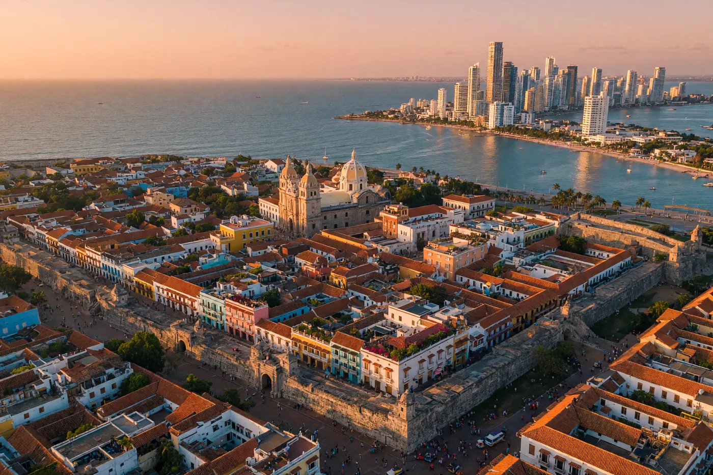 Aerial view of Cartagena's historic walled city (Ciudad Amurallada) at golden hour with the Caribbean Sea in the background