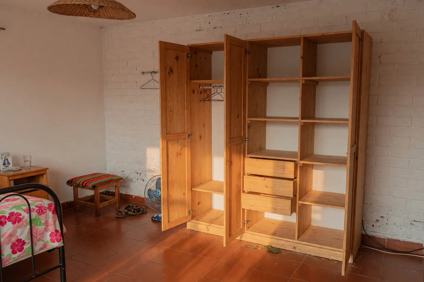 Clóset modular de madera vacío en una habitación de apartamento colombiano con piso de baldosa.
